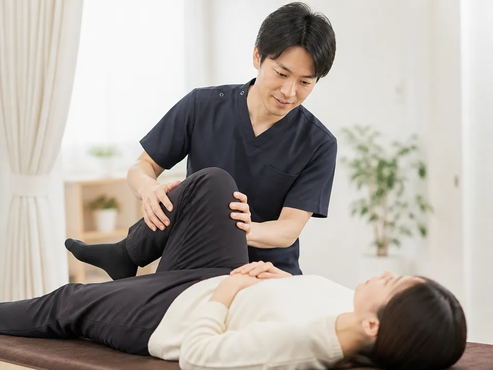 中村接骨院で痛くない整体術により患者の身体の状態を確認しながら施術している様子